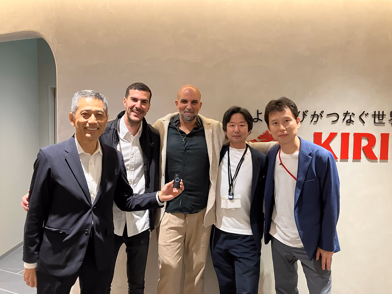 Kirin Group members with their arms around startup team members