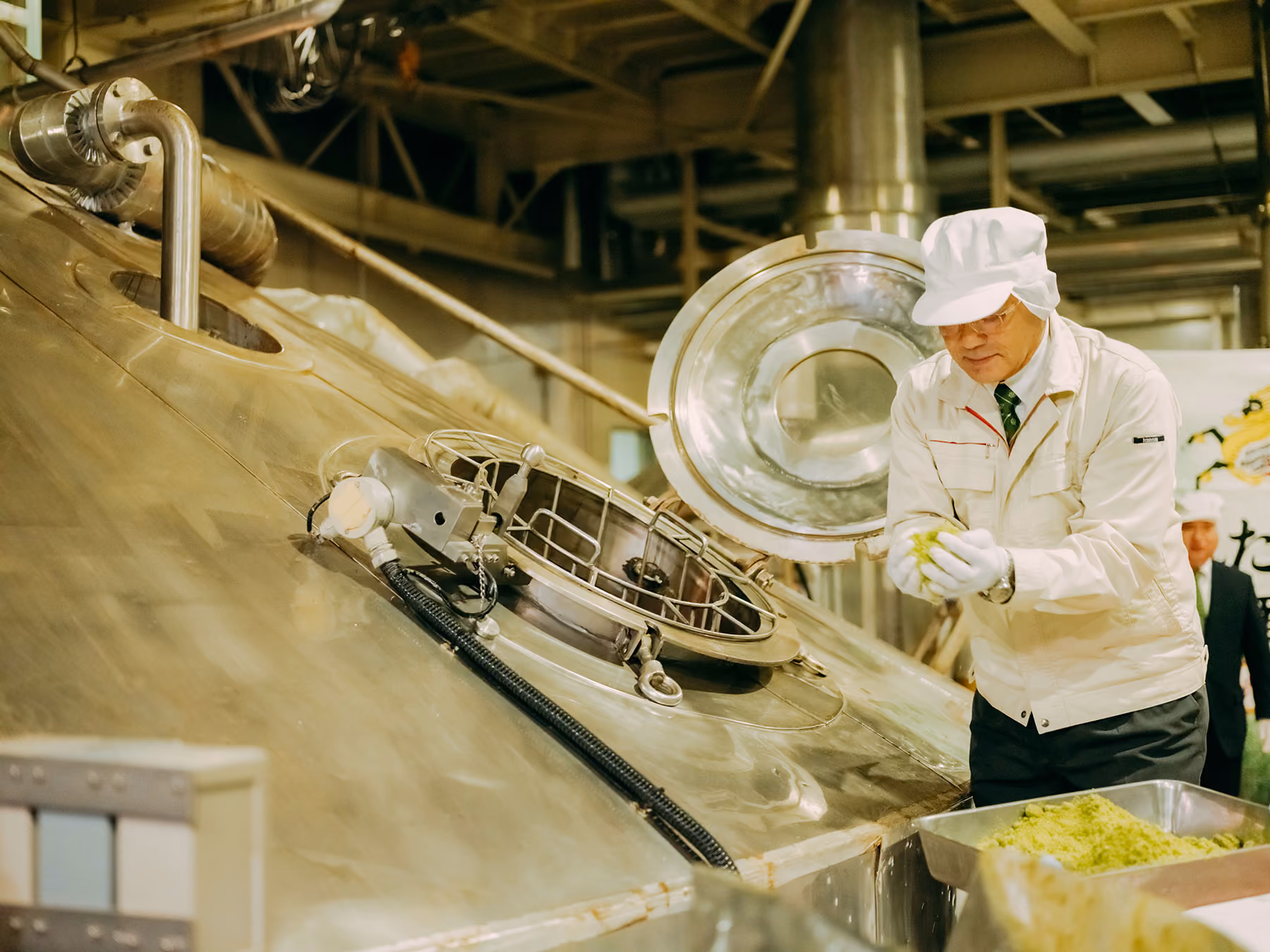 A scene from the mashing ceremony showing frozen hops being added to the mash tun